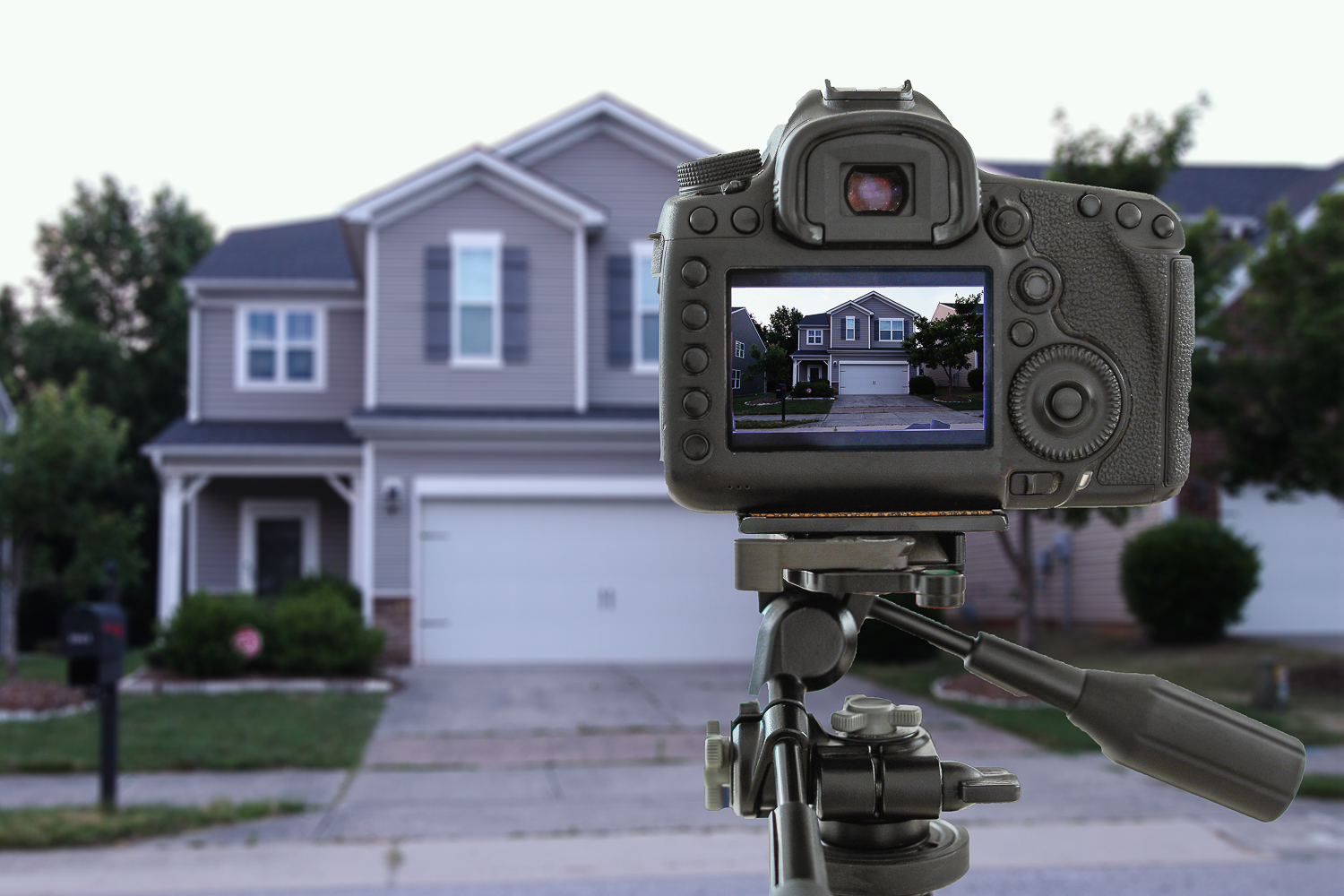 Camera viewfinder focusing on home with home blurred in the background