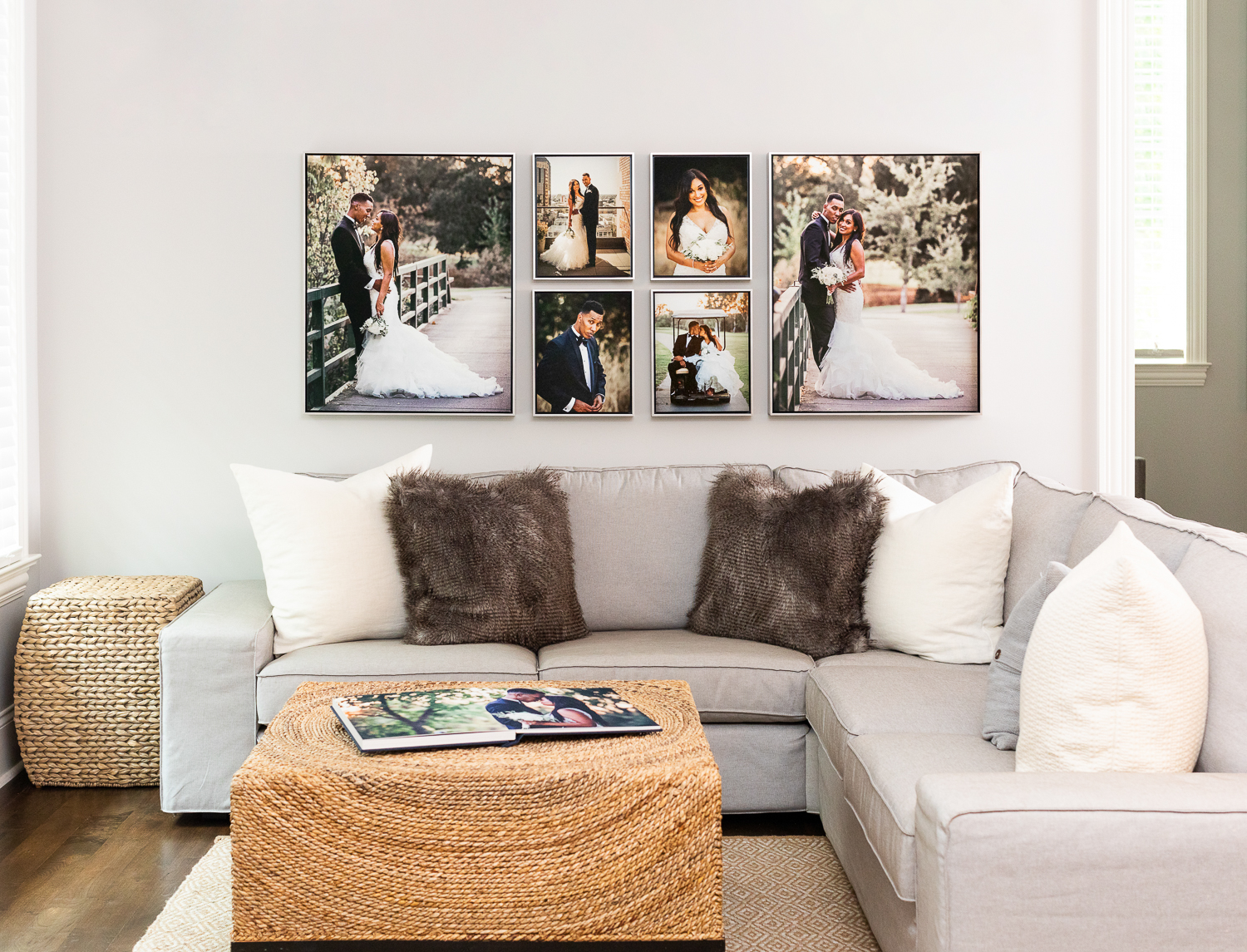 Beige living room couch with wedding photo collage hanging above